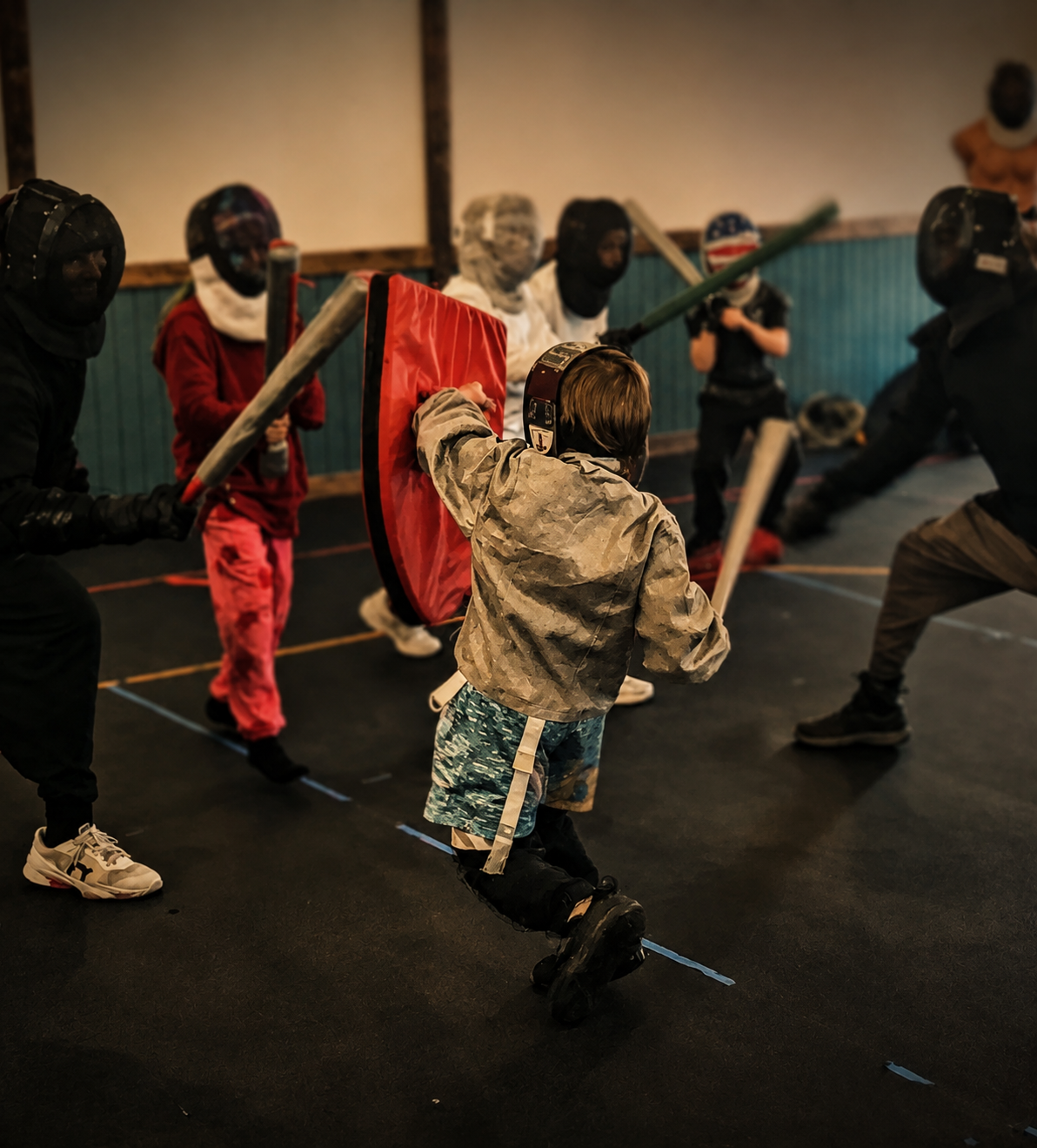 Kids sparring with foam swords at a themed birthday party